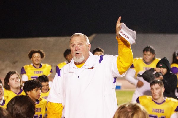 Coach Rich Tuman celebrates with his team after the Tigers defeated Frontier 56-21 Friday night to earn a title bout with Central Valley Christian on Friday, Nov. 25.